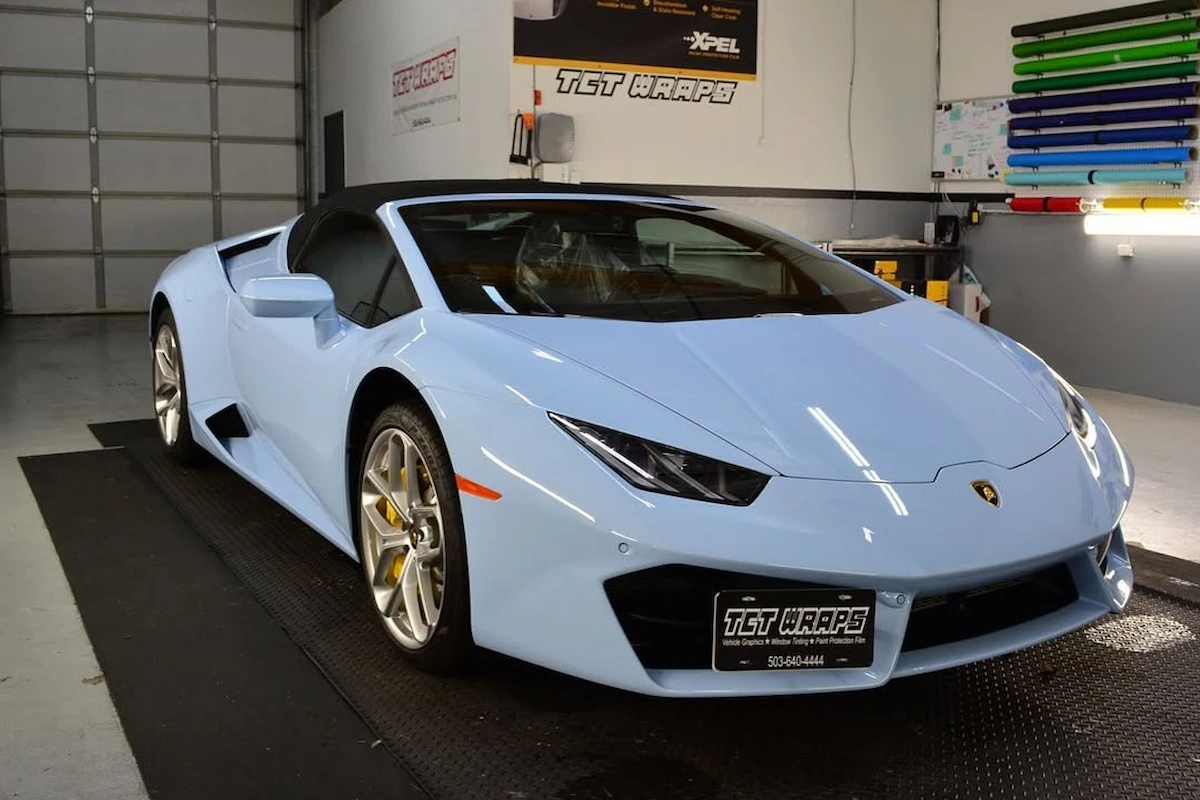 Supercar hood being protected with paint protection film
